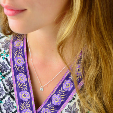 Personalised Sterling Silver Mini Moon and Star padlock necklace shown close up on model.