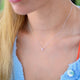 Girls mini slider initial charm necklace shown close up on model