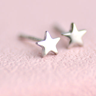 Sterling Silver Plain Minin star studs earrings shown close up .