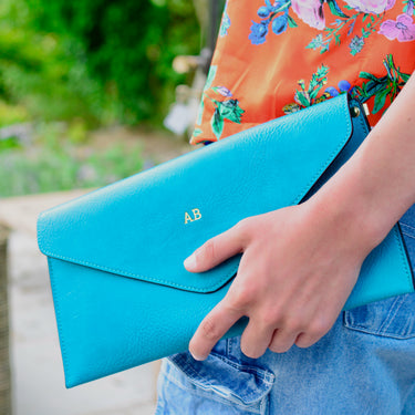 turquoise leather envelope clutch bag with gold monogrammed initials personalised
