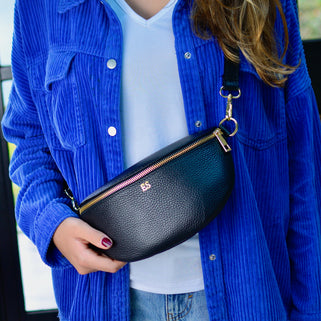 Monogram Leather Half Moon Chest Bag shown in black close up on model