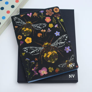 Monogram Bee's A5 Journal Notebook shown on top of black gift box with matching monogram.