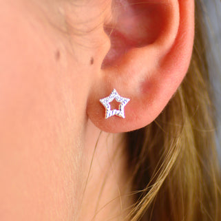 Sterling Silver CZ Open Star Stud Earrings shown close up.