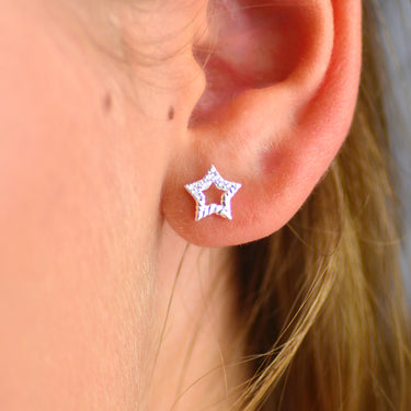 Sterling Silver CZ Open Star Stud Earrings shown close up.