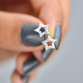 Sterling Silver CZ Open Star Stud Earrings shown close up.
