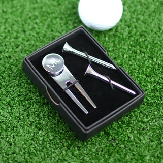 Golf Ball marker and tee set shown close up with engraving on ball marker shown close up in black gift box