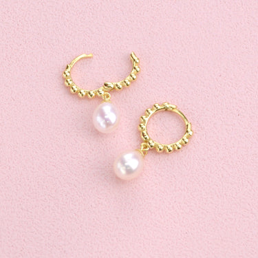 Gold beaded hoop earrings with pearl drops shown close  up  with hinged detail