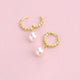 Gold beaded hoop earrings with pearl drops shown close  up  with hinged detail