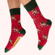Red socks with green accents and bicycle design on a white background
