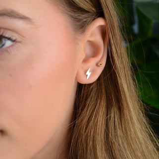 Silver Lightening bolt stud necklace shown in close up shot on model