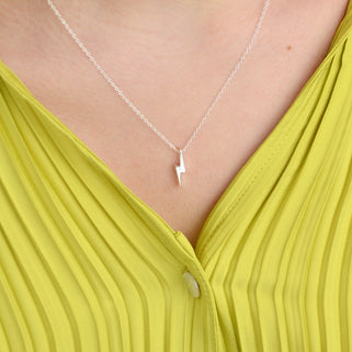 Sterling Silver Lightning Bolt Necklace shown in close up shot on model