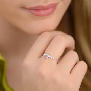 sterling silver love knot ring shown in close up shot on model