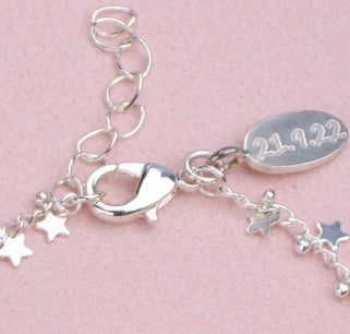 Engraved oval disc charm attached at the clasp