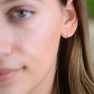 Simple Silver Sleeper Huggie Hoop Earrings shown close up on model