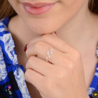 Sterling silver wave ring shown in close up shot on model