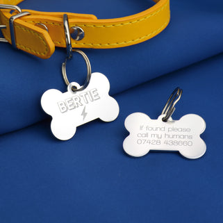 Personalised silver dog tag in bone shape with personalised engraved name "Bertie" in bold 3d font and lightning bolt icon