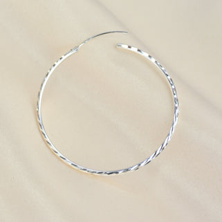 Sterling Silver Large Textured Hoop Earrings shown close up with hinge opening detail shown