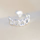 Silver open heart hoop earrings shown close up 