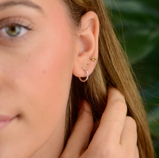 sterling silver hinged hoop shown in close up shot on model.