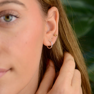 sterling silver hinged hoop shown in close up shot on model.