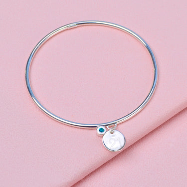 Sterling Silver Inital Birthstone bangle showing back of engraved circle charm with 21