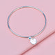 Sterling Silver Inital Birthstone bangle showing back of engraved circle charm with 21