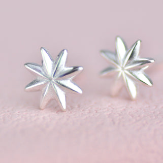 Sterling Silver Starburst Stud Earrings shown close up .