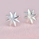 Sterling Silver Starburst Stud Earrings shown close up .