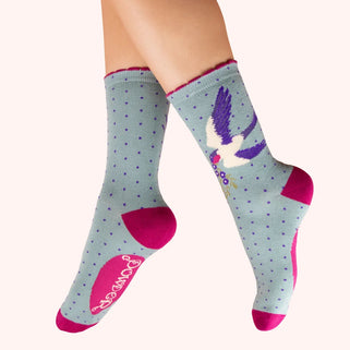 Gray socks with pink accents and a colorful design on a white background