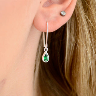 Sterling Silver Teardrop Birthstone Drop Earrings shown close up on model with May/Emerald birthstone