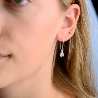 Sterling Silver Teardrop Birthstone Drop Earrings shown close up on model with May/Emerald Birthstone