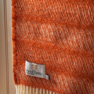 Close up shot of Twist Pumpkin orange wool Throw