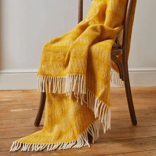 Twist Yellow Wool Throw shown draped over wooden chair