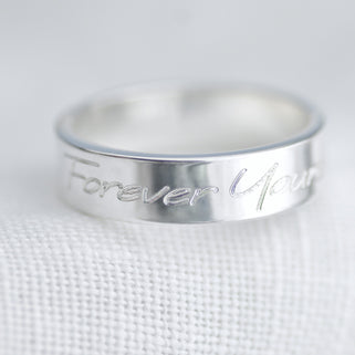 Personalised Unisex Silver Band Ring shown close up showing engraving on outside