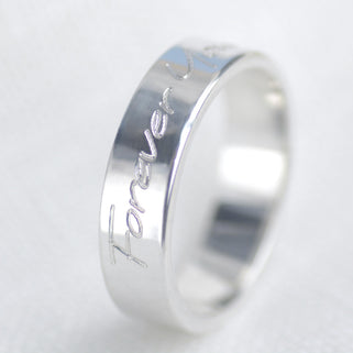 Personalised Unisex Silver Band Ring shown close  up showing engraving on outside