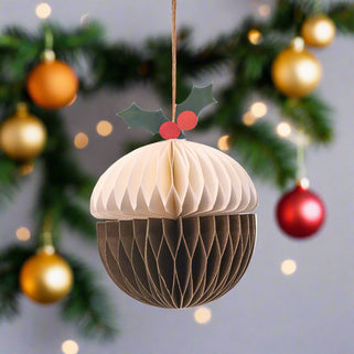 Cardboard Christmas ornament shaped like a bauble with holly on a white background