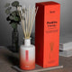 aery positive energy bamboo reed diffuser next to box