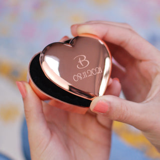 personalised rose gold plated heart trinket box with "B" in the centre and "08.11.2021" engraved underneath, shown in close up with model.
