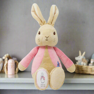 A soft plush pink toy bunny with embroidered facial features and floppy ears, designed for newborns and babies.