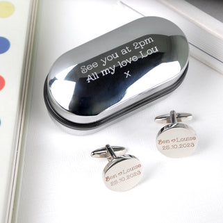 Oval chrome cufflinks box with personalised message "See you at 2pm All my love Lou x" engraved and matching round cufflinks with "Ben heart Louise 25.10.2023" engraved on both cufflinks.