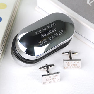 Oval chrome cufflinks box with personalised message "Mr & Mrs Baxter Est 25.06.22" engraved and matching rectangle cufflinks with "Mr & Mrs Baxter Est 25.06.22" engraved on both cufflinks.