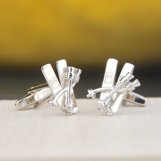silver ski cufflinks shown in close up shot.