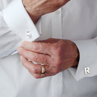 Personalised alphabet cufflinks in "S" and "R" shown on model