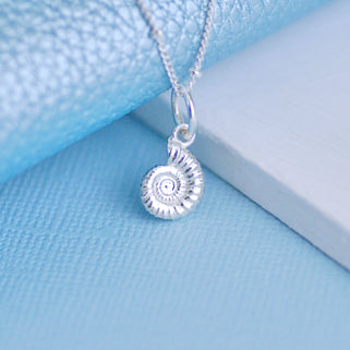 Sterling Silver Ammonite Charm on satellite chain necklace shown in close up