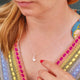 Sterling Silver Ammonite Charm on satellite chain necklace shown on close up of model