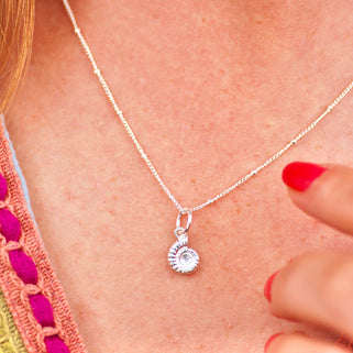 Sterling Silver Ammonite Charm on satellite chain necklace shown on close up of model