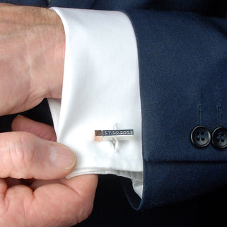 Silver Cuboid Cufflink with rose gold tip and "17.10.2028" engraved, shown on close up of models white shirt cuff