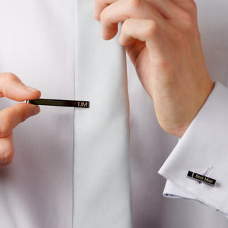 Gunmetal tie slide with "TJM" and matching cufflink with "Best Man" engraved shown on models tie and sleeve.