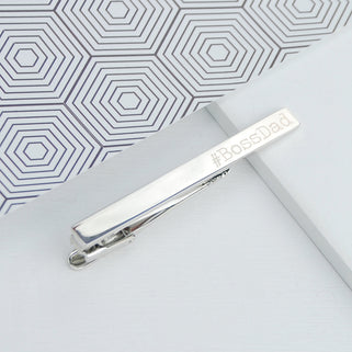 Silver tie clip with "#BossDad" engraved on the right hand side shown in close up shot 