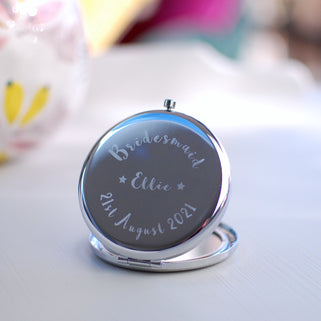Bridesmaid Compact Mirror with "Ellie" engraved in the centre, "Bridesmaid" engraved at the top and "21st August 2021" engraved across the bottom shown in close up shot
